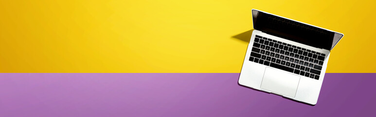 Laptop computer with shadow from above - overhead view