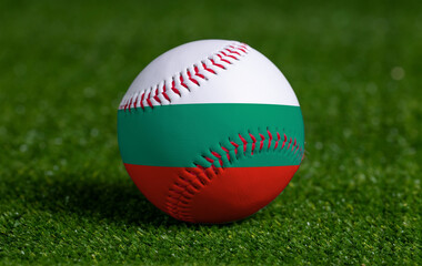 Baseball with Bulgaria flag on green grass background, close up