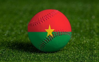 Baseball with Burkina Faso flag on green grass background, close up