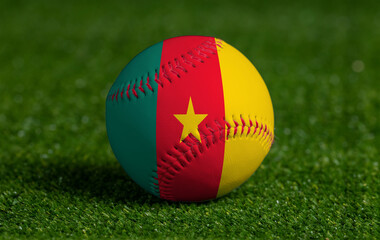Baseball with Cameroon flag on green grass background, close up