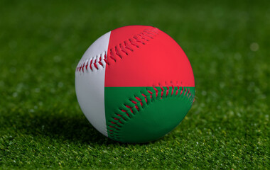 Baseball with Madagascar flag on green grass background, close up