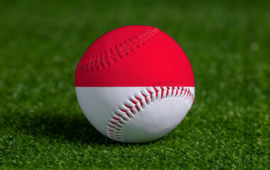 Baseball with Monaco flag on green grass background, close up