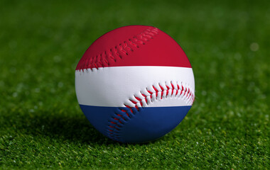 Baseball with Netherlands flag on green grass background, close up