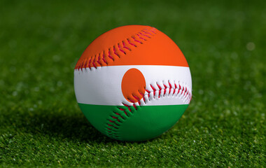Baseball with Niger flag on green grass background, close up