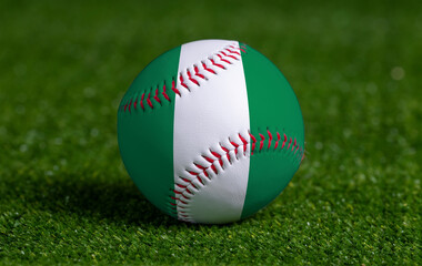 Baseball with Nigeria flag on green grass background, close up