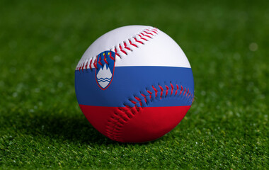 Baseball with Slovenia flag on green grass background, close up