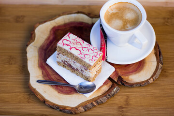 Tasty Slice of Cake with Cream Filling and Heart Decor on Top with Coffee on Cherry Board. Coffee Break