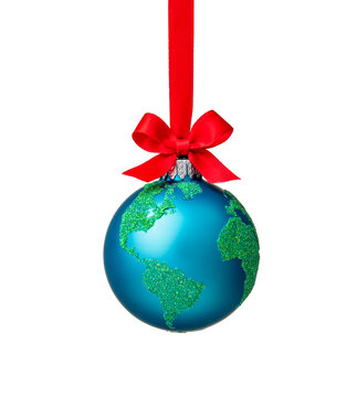 Globe christmas ornament isolated on white with a red bow. Peace on Earth, eco friendly or winter travel concept.