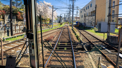 Japanese Kyoto local train traveling on rail tracks along the railway. Japan