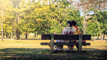 Maiko geisha taking selfie picture in park of Nara. Portrait with smartphone