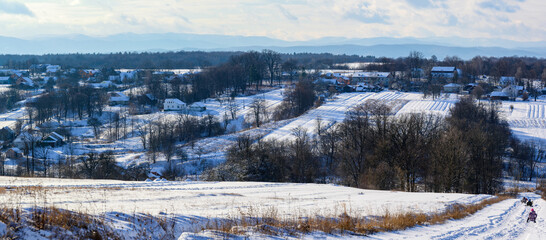 Ukrainian snow-covered villages, panorama of winter and evening villages.