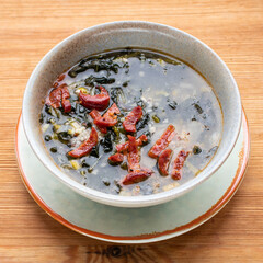 Portuguese cuisine soup with kale and chorizo sausage. Caldo verde soup.