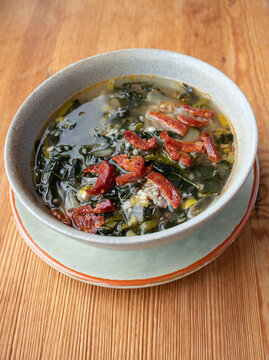 Portuguese cuisine soup with kale and chorizo sausage. Caldo verde soup.