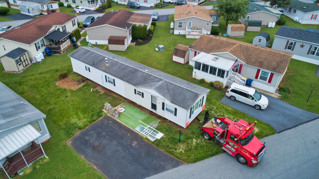 Aerial View of a Manufactured, Mobile, Prefab Home Being Removed from a Lot in a Park