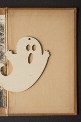phantom (ghost) laser cut plywood shape on an old book