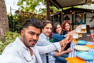 group of friends having fun at garden home party - Young people smiling together drinking beer