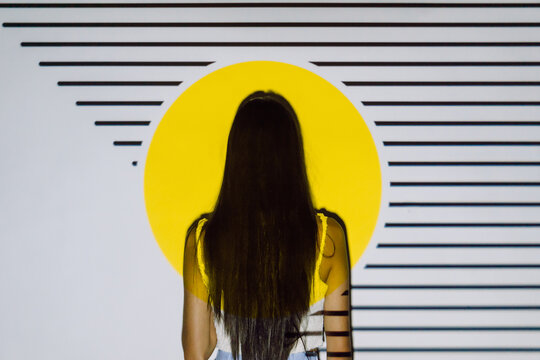 Tender ethnic model in crop top in projector light