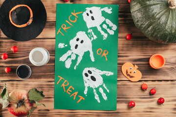 Step-by-step Halloween tutorial ghosts child's handprint. Step 10: Add Trick or Treat, or whatever...