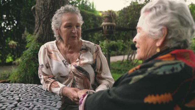 Elderly women talking in garden