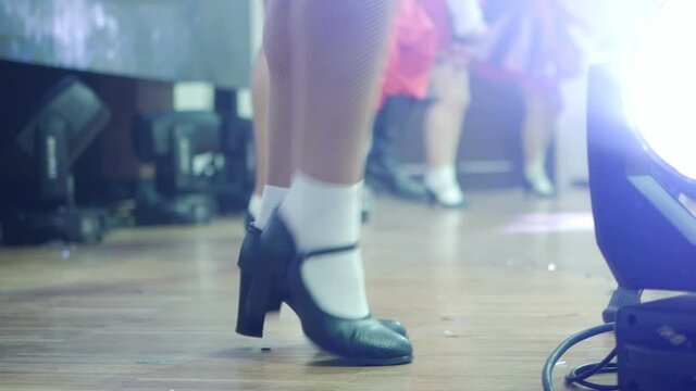Close-up of the legs of a group of women dancing traditional Irish dances. Dance ensemble legs