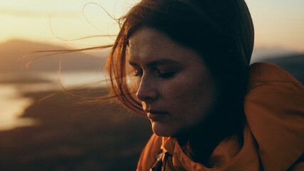 portrait of a woman at sunset in the mountains
