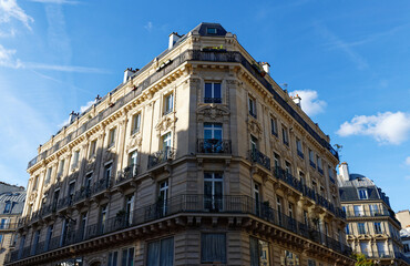 Fototapeta premium The facade of traditional French house with typical balconies and windows. Paris.