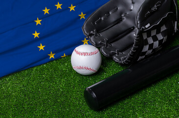 Baseball bat, glove and ball near European Union flag on green grass background