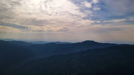 Fototapeta na wymiar Mountain range, aerial, evening, clouds, dawn, mist