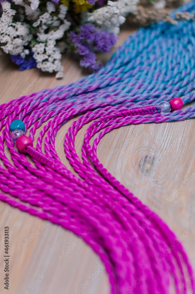 Wall mural colored braids, hair accessory on an elastic band