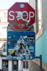 traffic signs stop and crosswalk filled with stickers