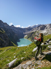 Young brunette woman hiking in Muttsee, in the swiss alps