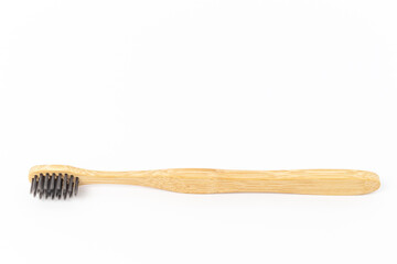 Bamboo toothbrush on white background with copy space.