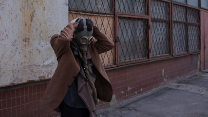 a woman walks down a gloomy street in a gas mask, mass infections and environmental problems,...