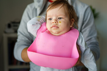 caucasian baby wearing silicone bib after meal front view portrait copy space