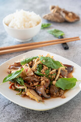 Stir fried Textured Vegetable Protein with mushroom, basil and chili on marble table for Chinese vegetarian food festival