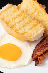 Sandwich with toasted French bread, egg and bacon.