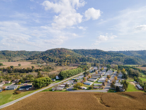 Rural Neighborhood And Farm Land In Autumn In Midwest; Mountains With Trees And Open Landscape; Farm Fields After Harvest; Family Friendly Single-family Homes And Mobile Home Park For Diversity.   