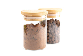 Jar of Ground and Whole Allspice on a White Background