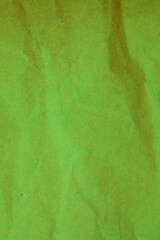 Green crumpled paper background.