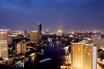 Fototapeta na wymiar Bangkok THAILAND - July 11 2020 : View landscape of Bangkok tower with river in the evening, downtown and cityscape in twilight at Thailand, skyscraper and condominium.