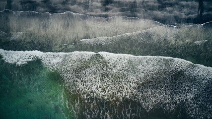 Aerial view of waves breaking over beach