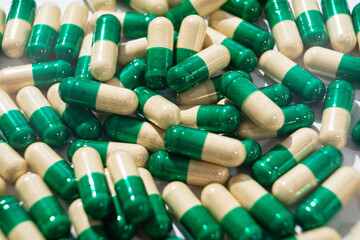 yellow-green medicine pills and capsules. pharmacy background