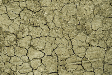 Brown dry cracked ground. Dried clay texture and patterns cracked surface of clay and land. Close up.