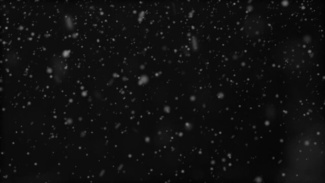 Snow fall over black background. Falling snow backdrop. Snowflakes falling down, closeup. Abstract winter wallpaper nature design. Snowfall. Slow motion video for screen mode using. 