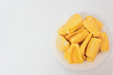 Ripe jack fruits isolated on white background. Fresh Jackfruit or Kathal in white plate, cutting jackfruit