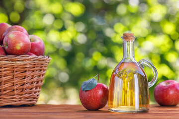 apple vinegar or cider in glass bottle outdoors