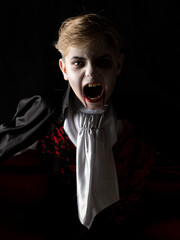 Boy in Halloween vampire makeup costume