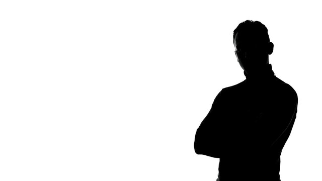 Photo of man's silhouette with arms crossed and copyspace