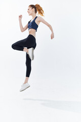 cheerful sportive woman with her leg raised workout lifestyle jumping