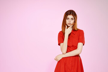 beautiful woman in red dress posing attractive look pink background